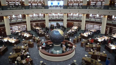 Interior view of an amazing crowded library with a globe on its center Stock Footage 145412763