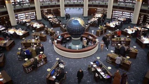 Interior view of an amazing crowded library with a globe on its center Stock Footage 145413062