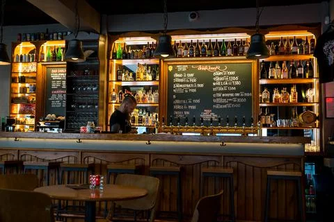 Interior view of the bar and bartender preparing for the evening Stock Photos
