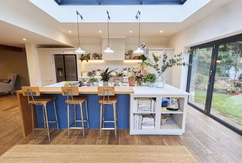 Interior View Of Beautiful Kitchen With Island Counter And Table For Children In Stock Photos