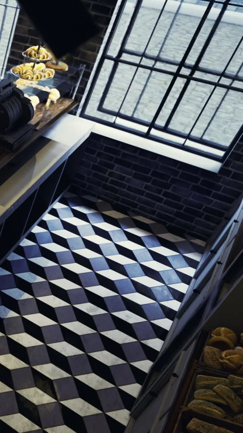 Interior view of a cafe showing patterned floor and window with baked goods Stock Footage 331662516