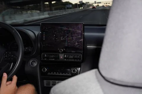 Interior view of a car dashboard while driving on the road. Stock Photos