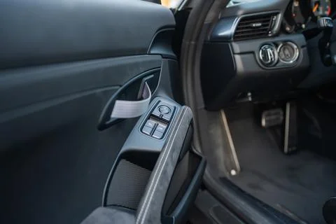Interior view of a car door panel with window controls, fabric pull handle,.. Stock Photos