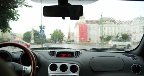 Interior view from car at stop light in rain with blurry traffic bokeh lights Stock Footage 340327521