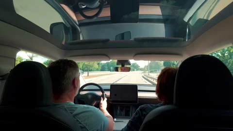 Interior view of car while driving under bright blue sky visible through Stock Footage 318994948