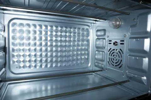 Interior view of a clean, empty electric oven with metal heating elements, .. Stock Photos