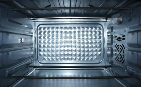 Interior view of a clean, empty electric oven with metal heating elements, .. Stock Photos