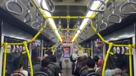 Interior view of a crowded city bus with passengers seated and standing. Видео 333937748