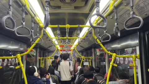 Interior view of a crowded city bus with passengers seated and standing. Stock-Footage 333937771