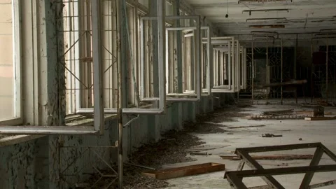 Interior View of a Decaying Hallway with Rhythmic Row of Empty Window Frames Stock Footage 321290999
