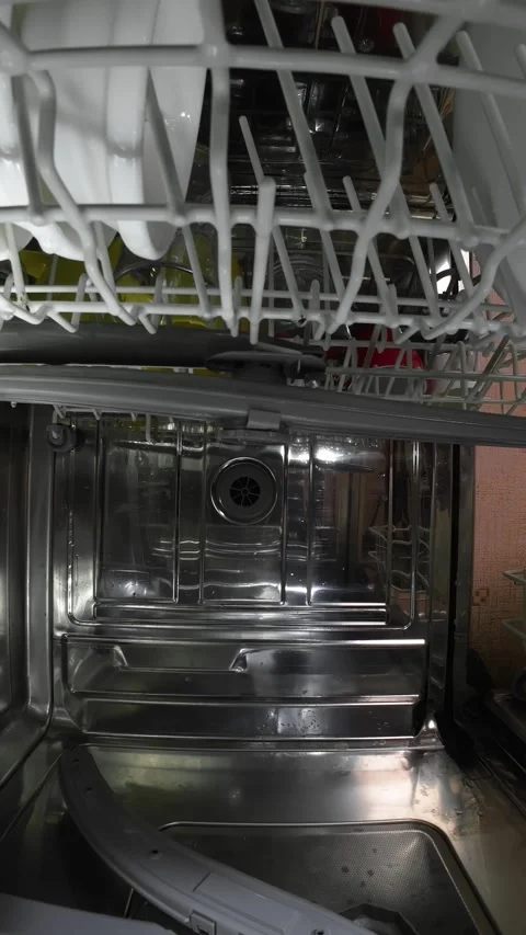 Interior view of dishwasher as dirty dish rack slides inside before washing Stock Footage 325508188