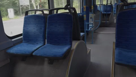 Interior view of empty city bus with blue seats and bright lighting Stock Footage 342578115