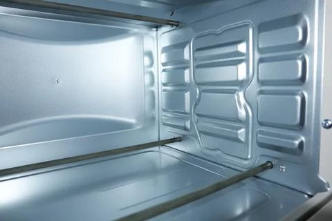 Interior view of an empty clean electric oven with silver metallic walls an.. Stock Photos