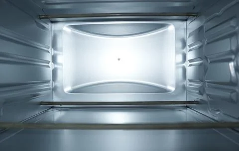 Interior view of an empty clean electric oven with silver metallic walls an.. Stock Photos