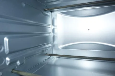 Interior view of an empty clean electric oven with silver metallic walls an.. Stock Photos