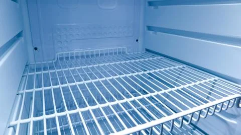 Interior view of an empty clean refrigerator looking slightly to the right .. Stock Photos