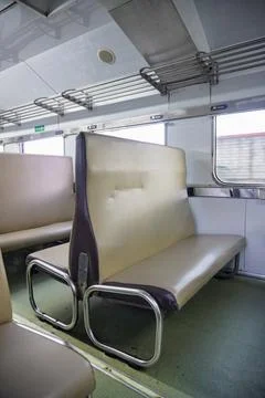 Interior view of an empty economy class train carriage with brown faux leather Stock Photos