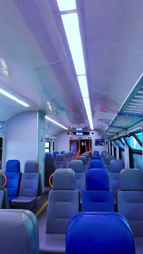 Interior view of an empty modern passenger train car with blue and gray seats Stock Footage 338398184