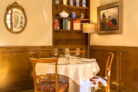 Interior view of an empty restaurant with a table in a corner. Stock Photos