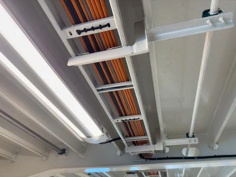 Interior view of ferry ceiling showcasing bright lighting and colorful cabl.. Stock Photos