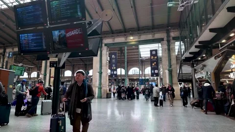 This is an interior view of the Gare du Nord station in Paris showing travelers Stock-Footage 330859735