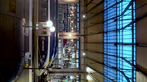 Interior view of Gare du Nord showing Eurostar train at platforms under glass Stock Footage 331055253