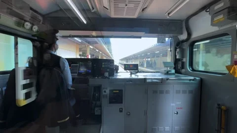 Interior view of a high-speed train cockpit approaching a station in Tokyo Stock Footage 305636372