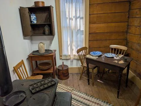 Interior view of a historic kitchen featuring a wood-burning stove Stock Photos