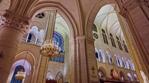 Interior view of a historic Notre Dame cathedral with grand chandeliers and Stock Footage 303974071