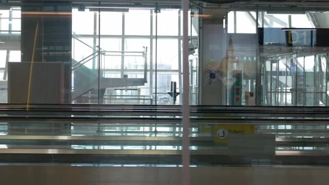 Interior view inside airport terminal departure gate from moving escalator .. Stock Footage 274486129
