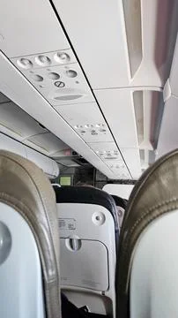 Interior view from inside a comercial flight through the airplane seats. Stock Photos