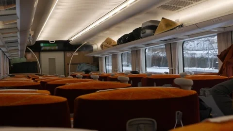 Interior view inside express train cabin while running moving through snowy.. Video stock 328102130