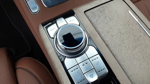 Interior view with joystick control media system and brown leather of luxur car Stock Footage 112661789