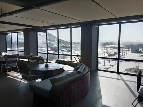 Interior view of a lounge area with large windows Stock Photos