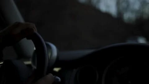 Interior view of male hand on steering wheel in car at night. Road trip, Stock-Footage 336266137
