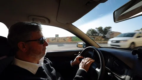 Interior view of a man driving Stock Footage 103135533