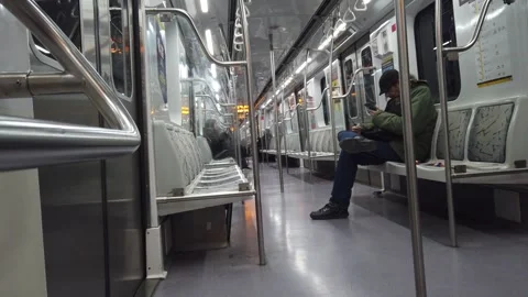 Interior View of Man Sitting Alone Using Smartphone Inside Subway Metro Train Stock Footage 337528100