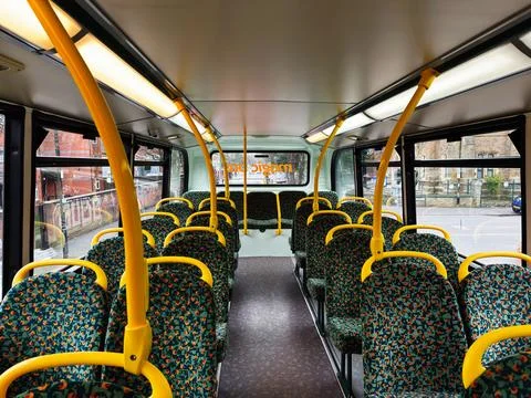 Interior view of a Manchester Magic bus with green patterned seats and yell.. Stock Photos