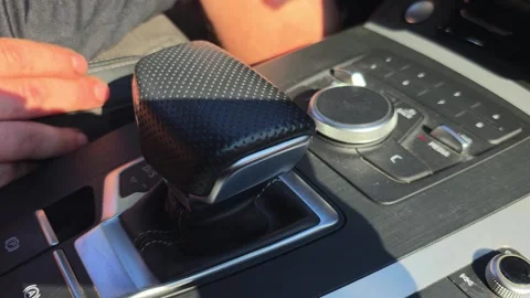 Interior view of modern car dashboard with black textured gear shifter and Stock Footage 344846452