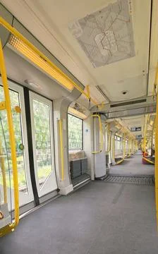 Interior view of modern subway train with yellow accents and open doors Stock Photos