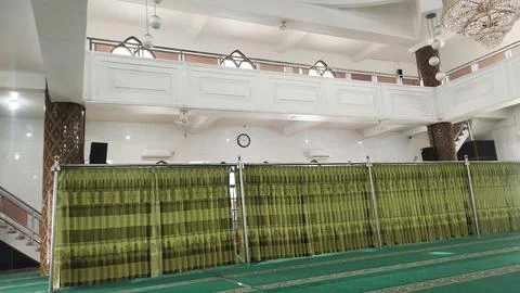 Interior view of a mosque featuring curtains and a prayer area. Stock Photos