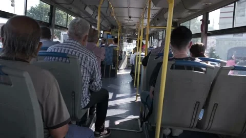 Interior view of a municipality public bus with some passengers wearing mask Stock Footage 158054888