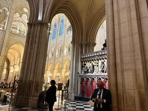 Interior view of Notre Dame Cathedral in Paris, France with visitors, gothi.. Stock Photos