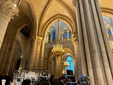 Interior view of Notre Dame cathedral gift shop and nave with chandeliers a.. Stock Photos