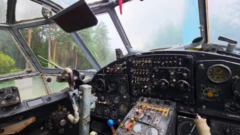 Interior view of old airplane cockpit showing instrument panel and pilot Stock Footage 341657760
