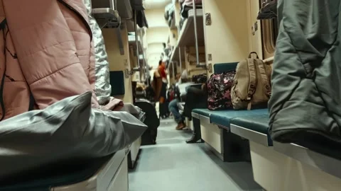 Interior view of open-plan Russian platzkart train carriage at night with Stock Footage 341658144