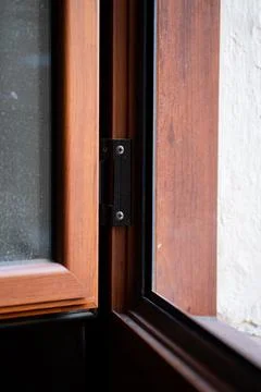 Interior view of an open window frame showing glass panels, a black hinge detail Stock Photos