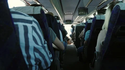 Interior view of passenger bus moving along road with people sitting in seats Vídeos de archivo 334558185
