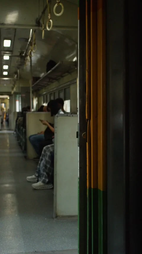 Interior View of Passengers Commuting on a Moving Train in Bangkok Stock Footage 339119314
