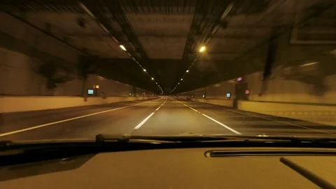 Interior view personal perspective of a car driving through a tunnel at night Stock-Footage 82690813